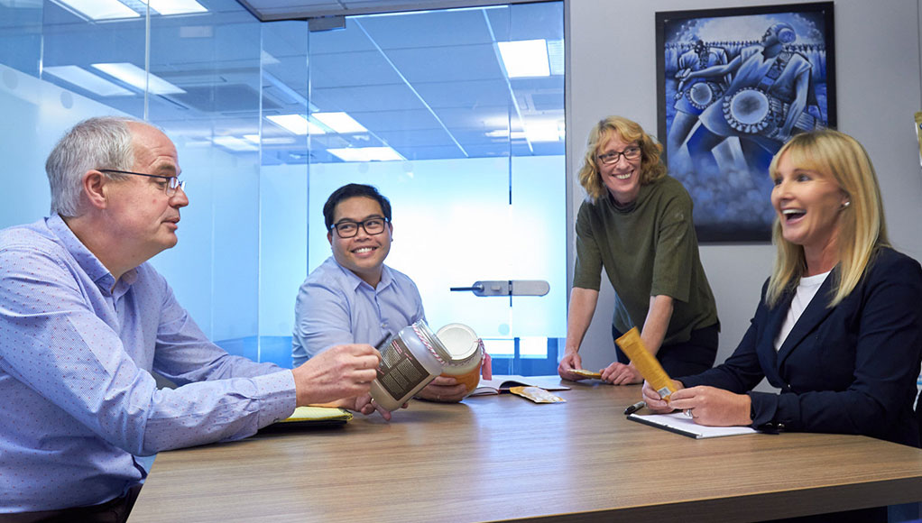 The Team at Complex Nutrition having a meeting around a table, discussing a new product